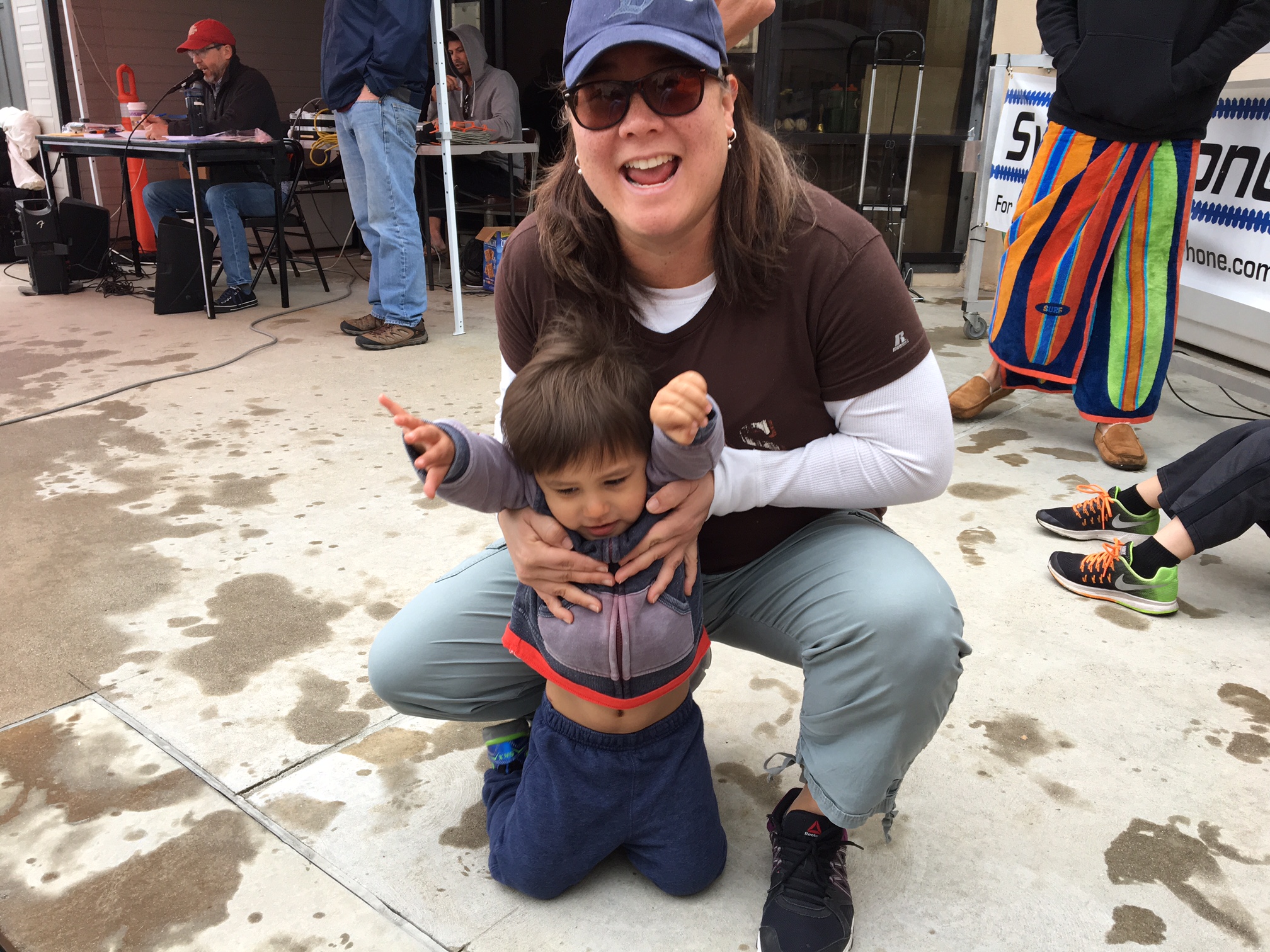 Si, in sunglasses, smiling on pooldeck