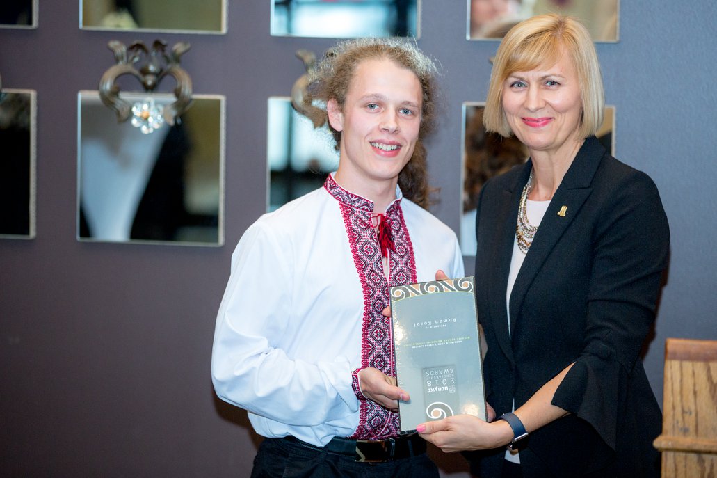 Roman and UCU Director Natalia Lishchyna holding an award Certificate