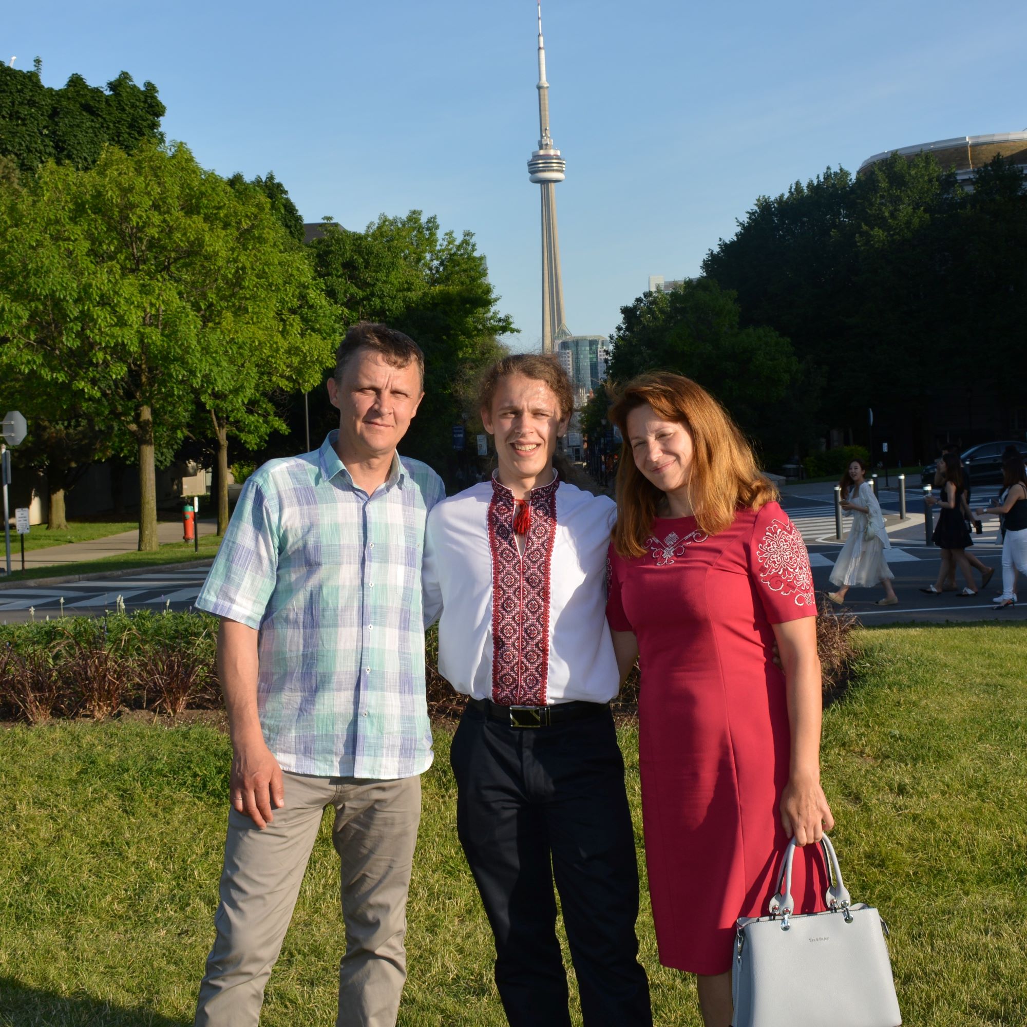 Roman and his parents in front of the CN Tower.