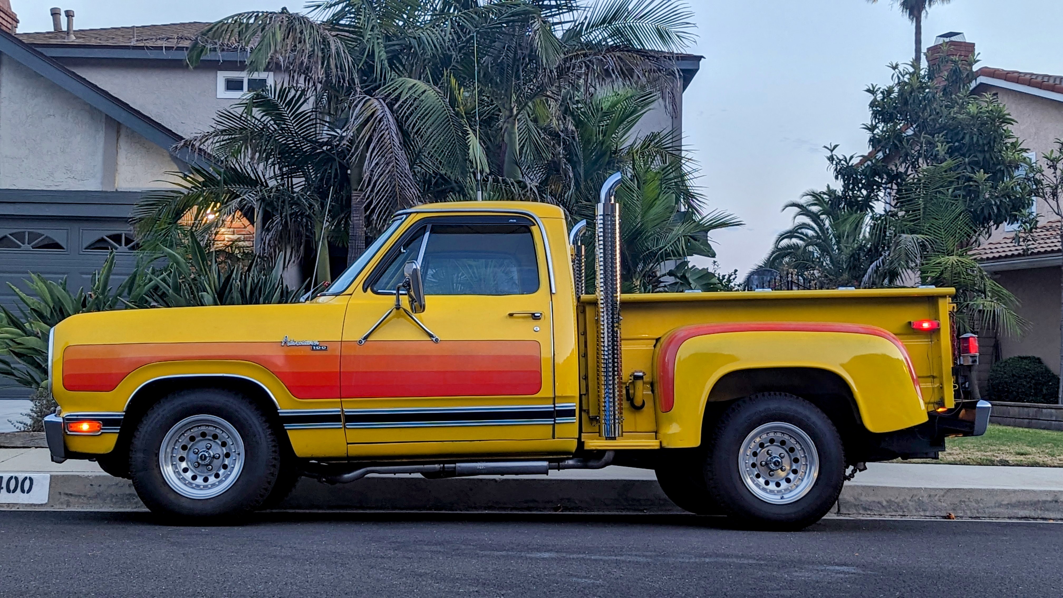 Yellow Dodge D-100 Pickup with Exaust Stacksand orange stripes